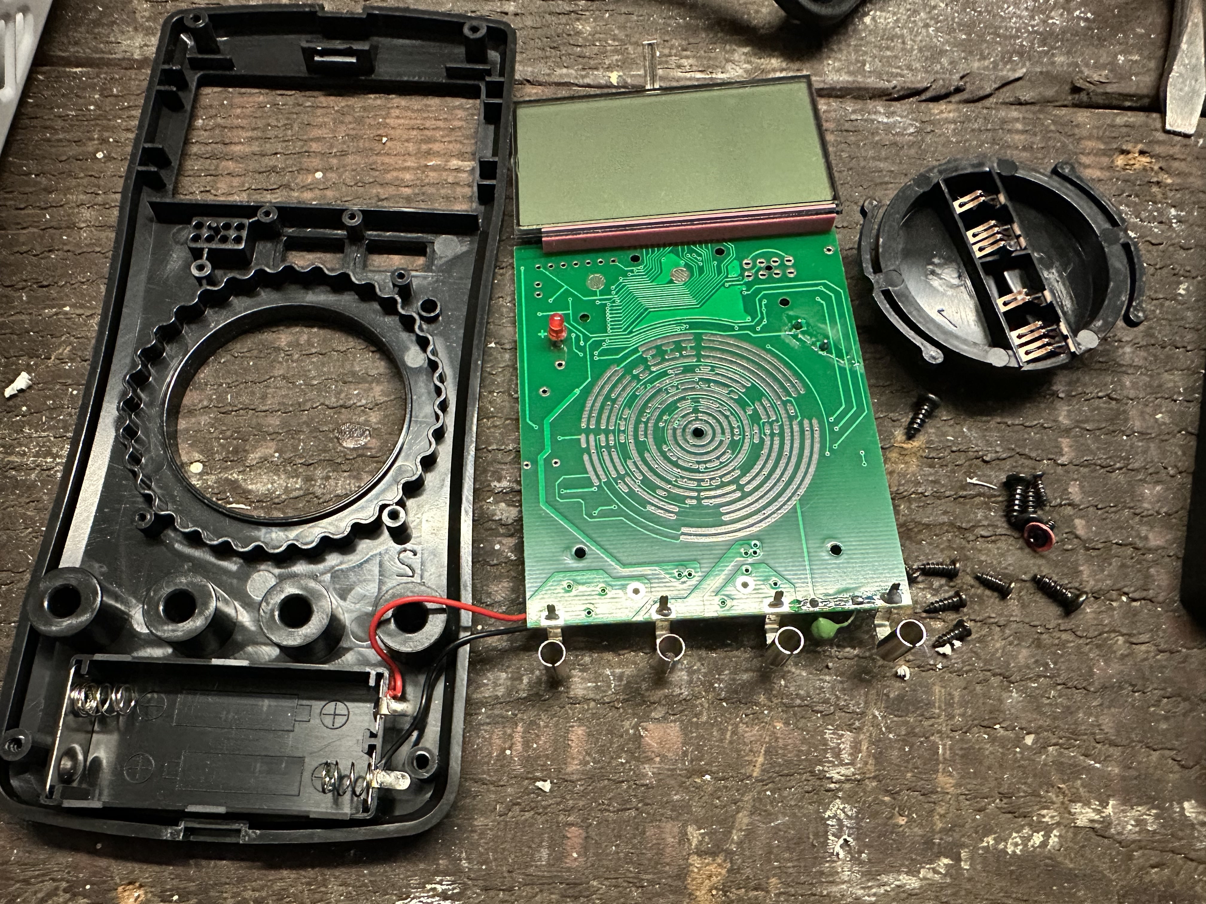 Disassembled ANENG-SZ08 multimeter showing the poorly designed rotary control mechanism